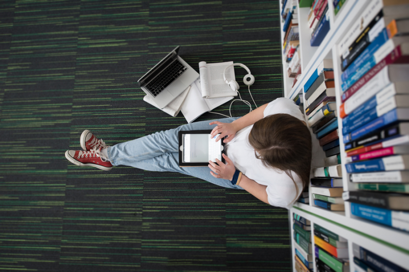 girl-sitting-on-library-floor